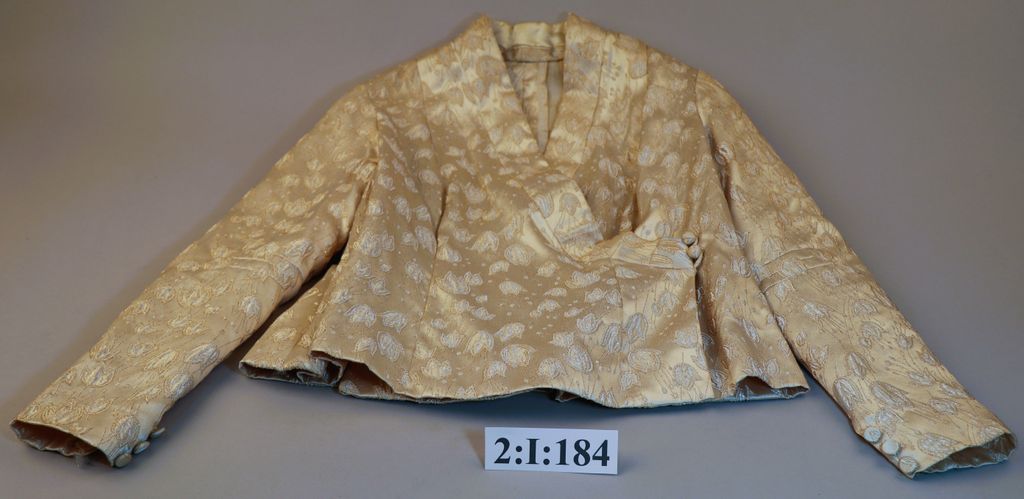 ເສື້ອຄໍປ້າຍ ຜ້າໄໝ ລາຍດອກສີງາຊ້າງ.