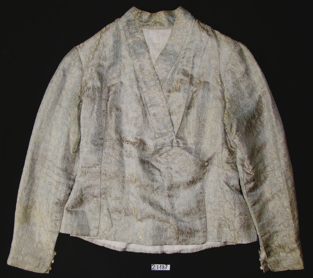 ເສື້ອຄໍປ້າຍ ຜ້າໄໝ ລາຍດອກສີໝົ່ນ.